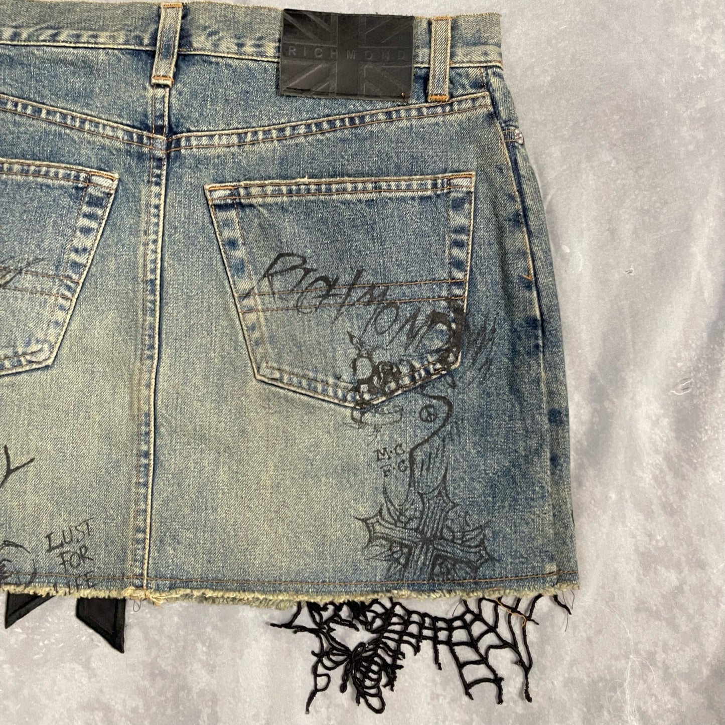 Richmond embellished mini denim skirt with script graphic (S)